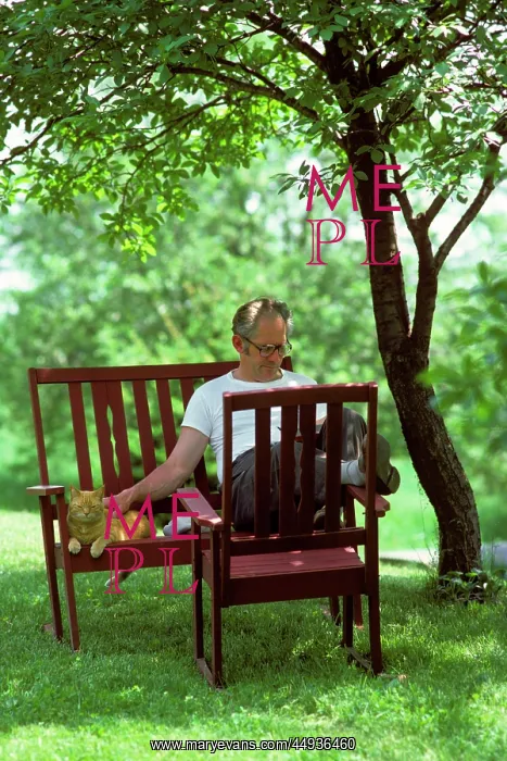 : Retired Relaxed Man Sitting in Backyard under : Retired Relaxed Man Sitting in Backyard under