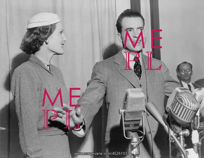 : Richard Nixon standing behind microphones with : Richard Nixon standing behind microphones with