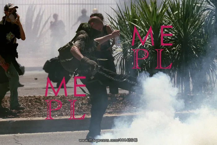 : Rioter Kicks Away Tear Gas : Rioter Kicks Away Tear Gas