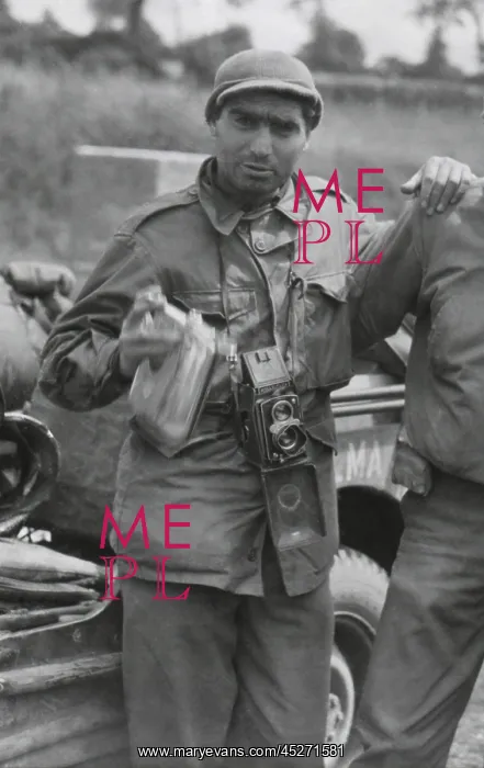 : Robert Capa, in France while on assignment photographing : Robert Capa, in France while on assignment photographing