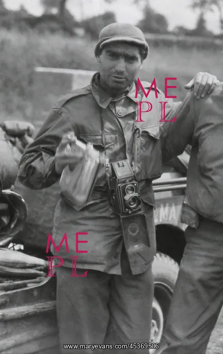 : Robert Capa, in France while on assignment photographing : Robert Capa, in France while on assignment photographing