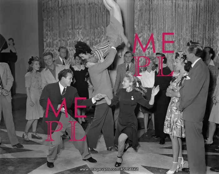  : Room full of couples dancing the jitterbug