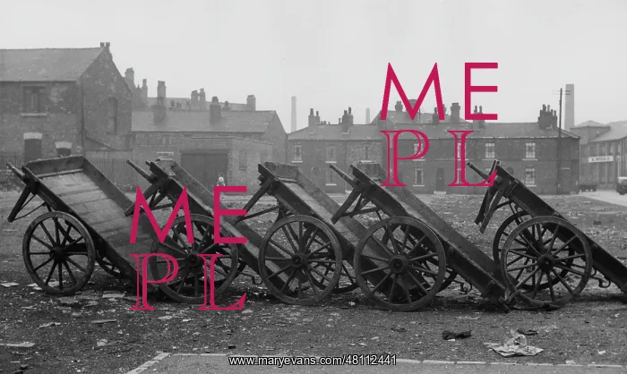 : A row of upturned carts on waste ground : A row of upturned carts on waste ground