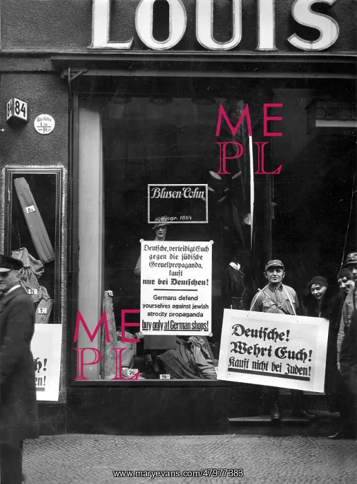 : SA Guards. An SA Guard stands in front of a Jewish clothes shop : SA Guards. An SA Guard stands in front of a Jewish clothes shop