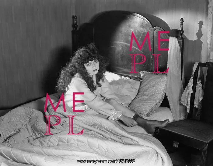 : Sad woman sitting in bed : Sad woman sitting in bed