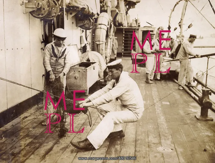 : Sailor binding a swab, sitting on a rope, WW1 : Sailor binding a swab, sitting on a rope, WW1