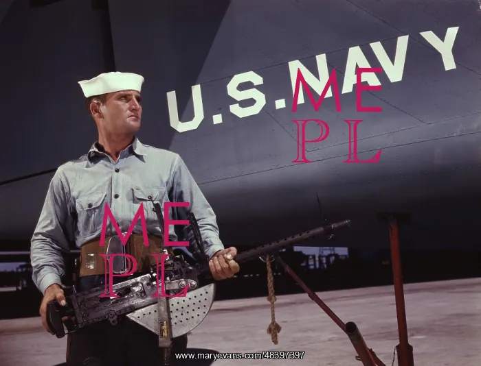 : Sailor holding a.30-caliber machine gun in : Sailor holding a.30-caliber machine gun in