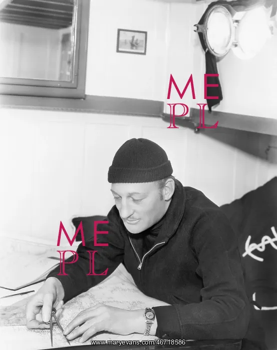  : Sailor looking over a map with a compass