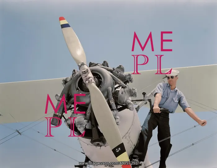 : Sailor starts the engine of a N3N taining biplane, 1942 : Sailor starts the engine of a N3N taining biplane, 1942