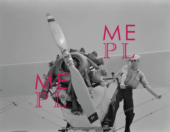 : Sailor starts the engine of a N3N taining biplane, 1942 : Sailor starts the engine of a N3N taining biplane, 1942