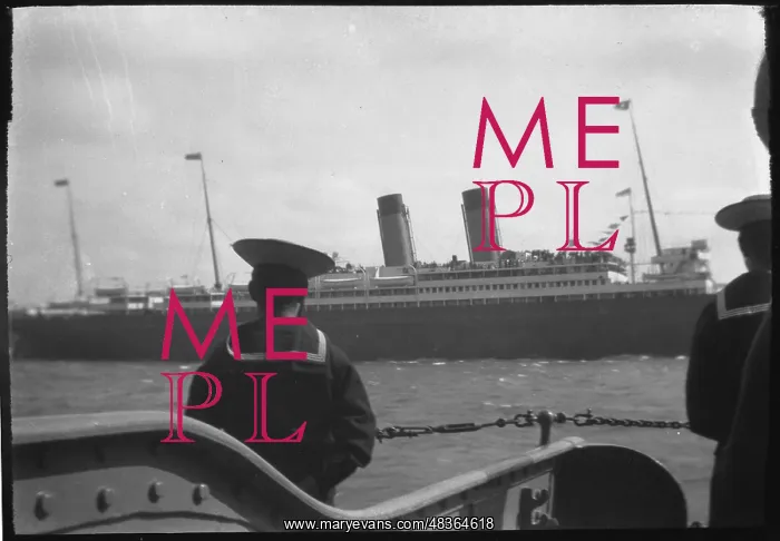  : A sailor watches a passing ship