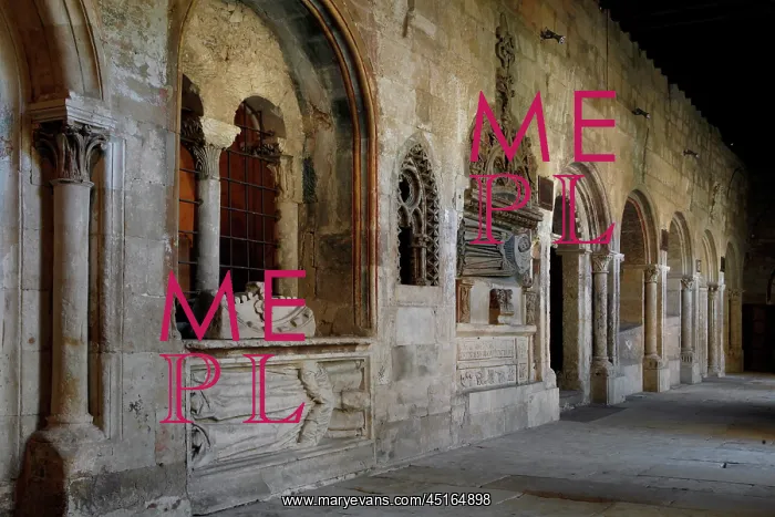 : Salamanca. Low angle view of Romanesque cloister alley with tombs : Salamanca. Low angle view of Romanesque cloister alley with tombs