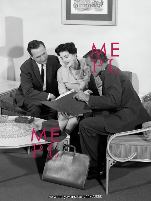 : Salesman showing folder to couple at home in : Salesman showing folder to couple at home in
