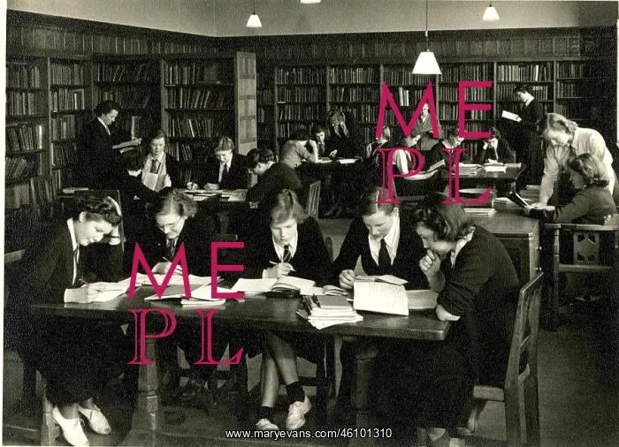 : Schoolgirls in uniform studying in a library : Schoolgirls in uniform studying in a library