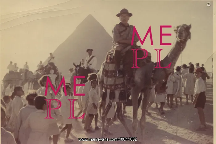 : Scout leader on camel in front of pyramid, Egypt : Scout leader on camel in front of pyramid, Egypt