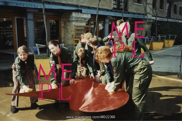 : Scouts cleaning propeller near Tower Bridge, London : Scouts cleaning propeller near Tower Bridge, London