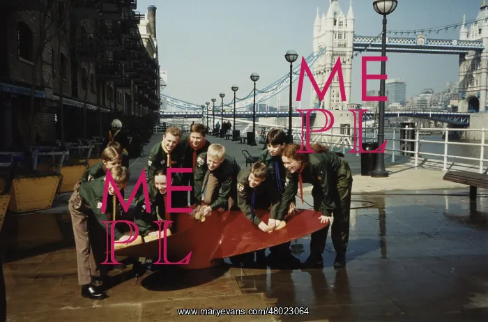 : Scouts cleaning propeller near Tower Bridge, London : Scouts cleaning propeller near Tower Bridge, London