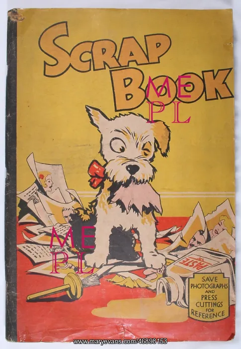 : Scrap book with a dog chewing paper : Scrap book with a dog chewing paper