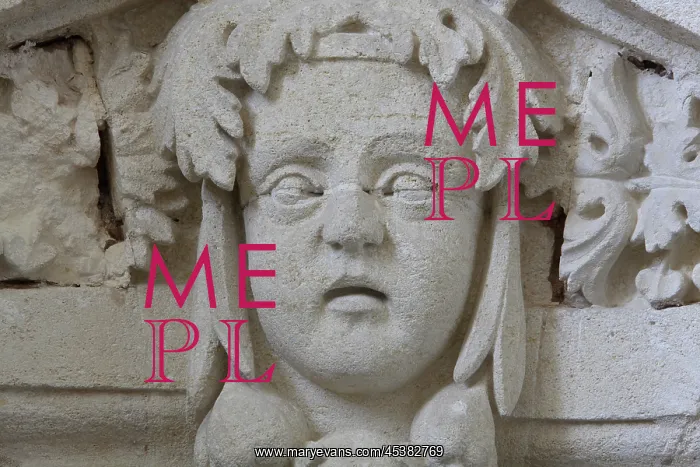 : Sculptural detail of a head on a pediment above : Sculptural detail of a head on a pediment above
