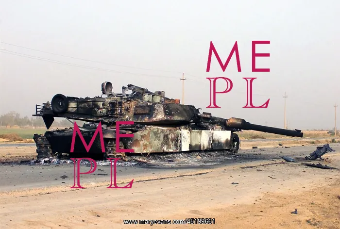 : A scuttled Abrams Tank rests in front of ? : A scuttled Abrams Tank rests in front of ?