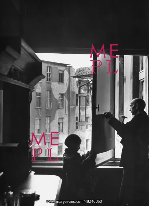 : Sealing a window with cardboard, 1943 : Sealing a window with cardboard, 1943