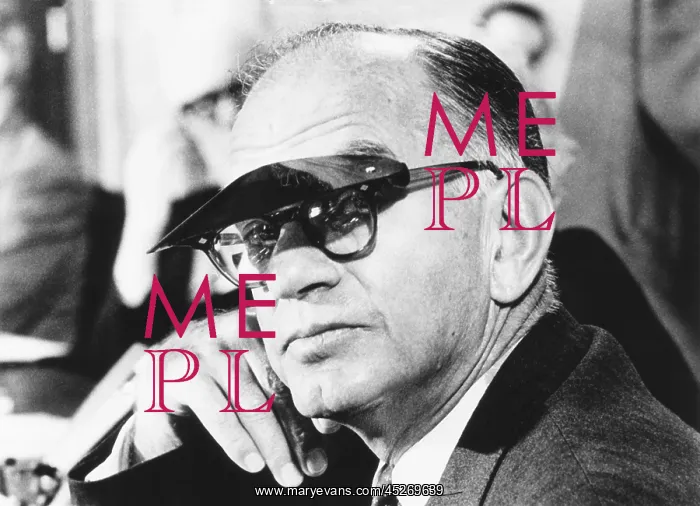 : Sen. J. William Fulbright wears a sun visor to : Sen. J. William Fulbright wears a sun visor to