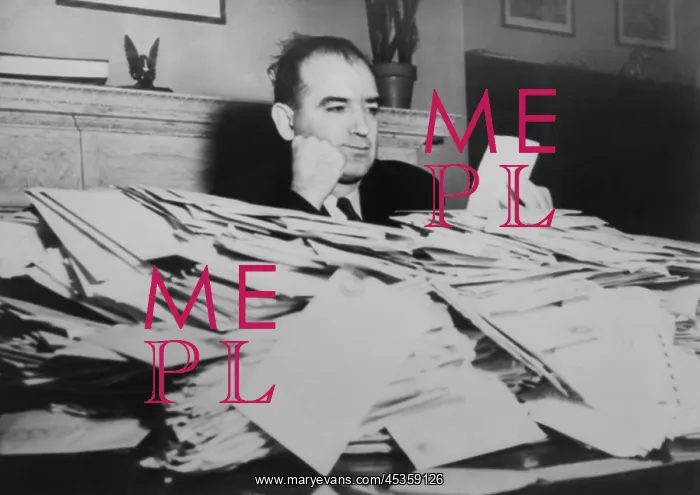 : Sen. Joseph R. McCarthy sits at desk piled high : Sen. Joseph R. McCarthy sits at desk piled high