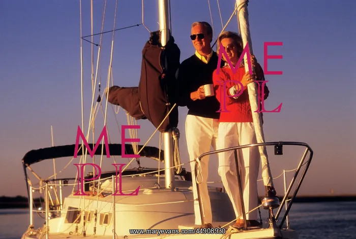 : Senior Couple Standing on Front Deck of Sail Boat : Senior Couple Standing on Front Deck of Sail Boat