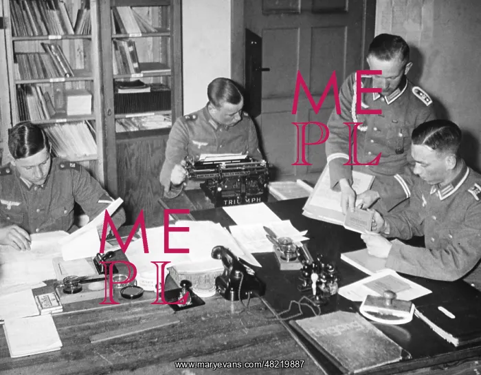 : A sergeant gives documents to workers in an orderly room : A sergeant gives documents to workers in an orderly room