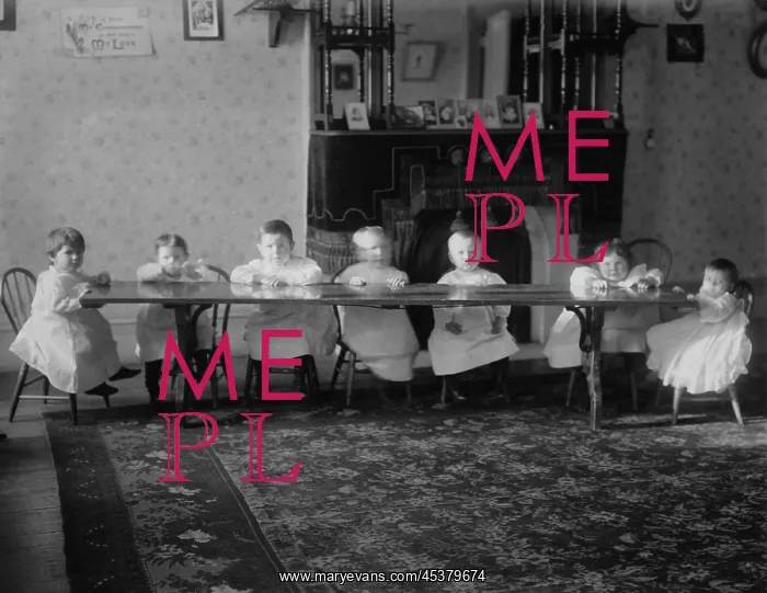 : Seven toddlers sit at a table at the Childrens : Seven toddlers sit at a table at the Childrens
