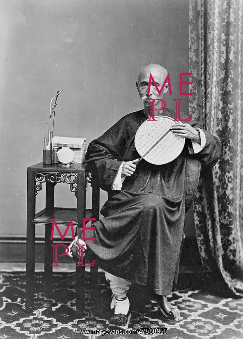 : Shaven-headed man with pipe and fan, China : Shaven-headed man with pipe and fan, China