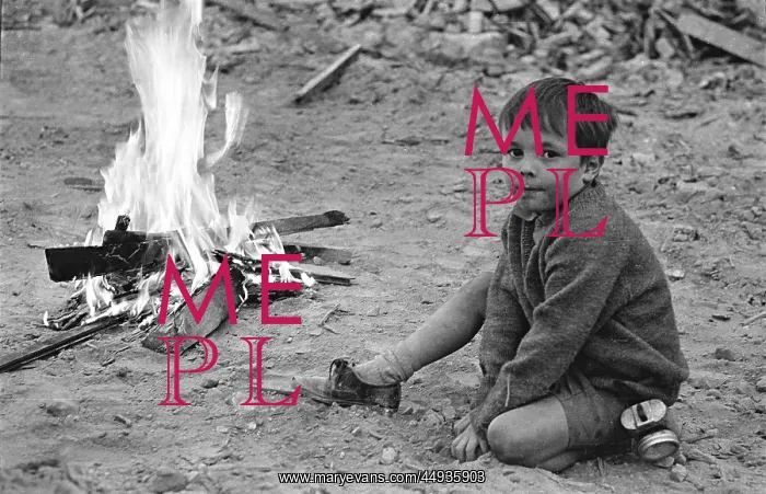 : Shepherds Bush London, boy with fire on demolition site : Shepherds Bush London, boy with fire on demolition site