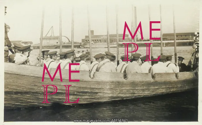 : Ship's crew in rowing boat with oars held vertically : Ship's crew in rowing boat with oars held vertically