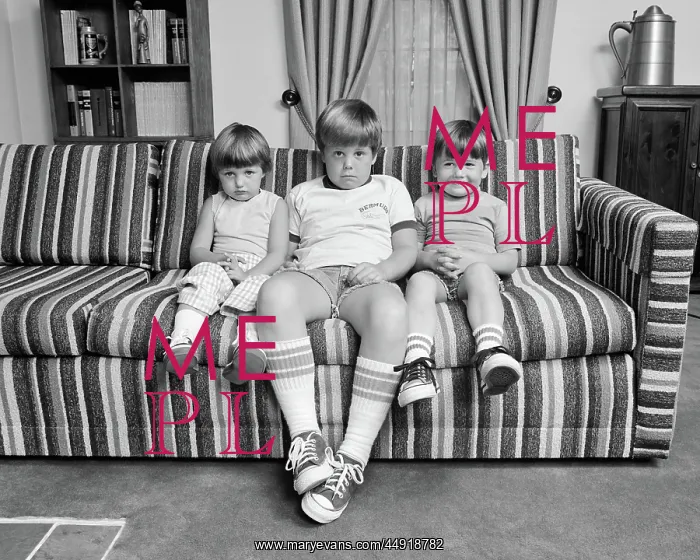 : Three Siblings Sitting on Couch Looking at Camera : Three Siblings Sitting on Couch Looking at Camera
