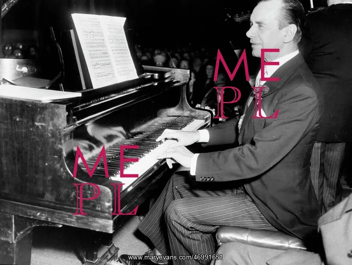 : Sir Malcolm Sargent, conductor, playing piano in a concert : Sir Malcolm Sargent, conductor, playing piano in a concert