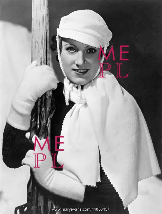 : SKI-WEAR. A lady skier models matching accessories of white gauntlets : SKI-WEAR. A lady skier models matching accessories of white gauntlets