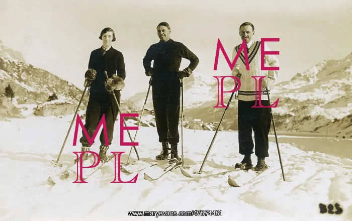  : Skiers on top of a show covered mountain
