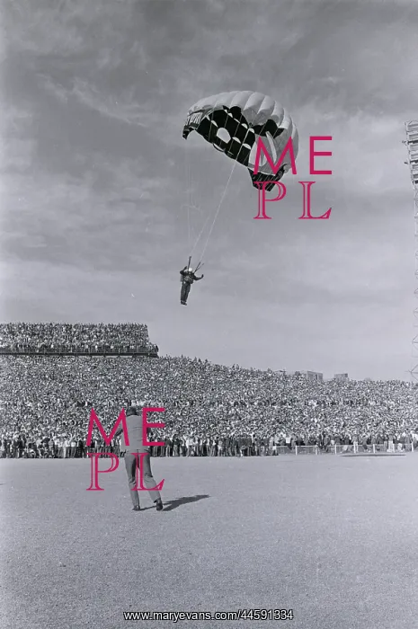: A skydiver, one of a team of three, prepares to : A skydiver, one of a team of three, prepares to