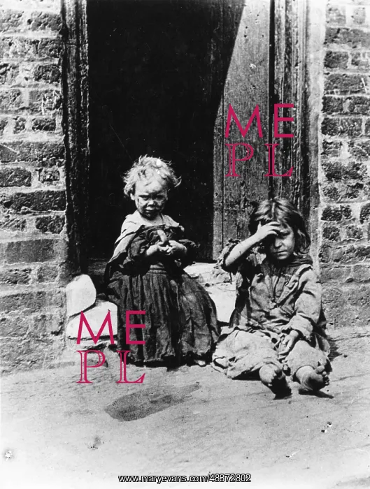 : Slum children sitting in a doorway : Slum children sitting in a doorway