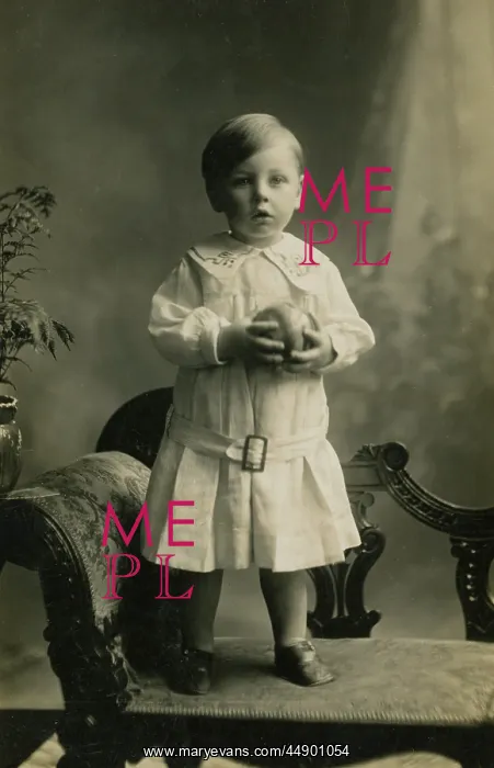 : Small boy standing on chaise-longue : Small boy standing on chaise-longue