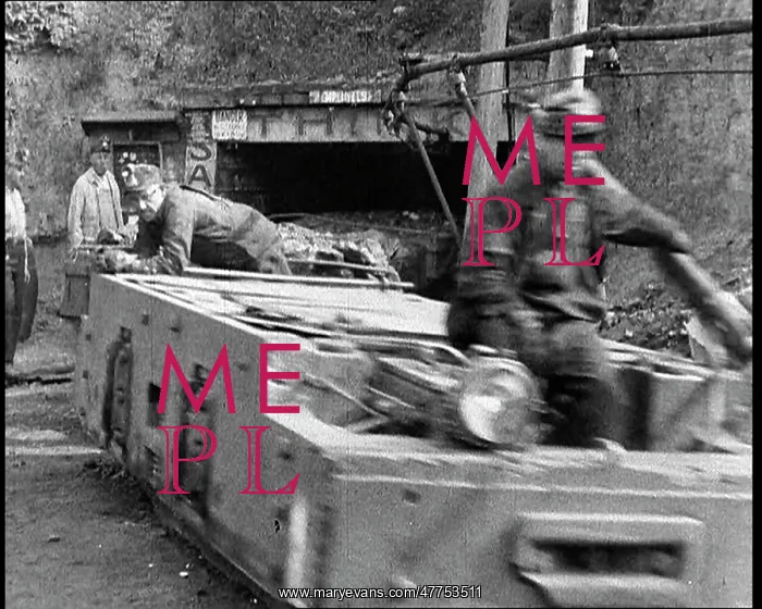 : Small Train Towing Coal Wagons Coming Out of a Mine : Small Train Towing Coal Wagons Coming Out of a Mine
