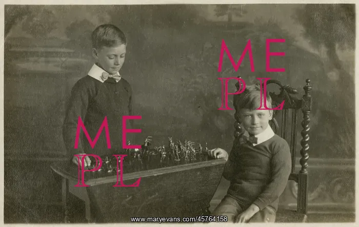 : Two smart young boys play with their model tin soldiers : Two smart young boys play with their model tin soldiers