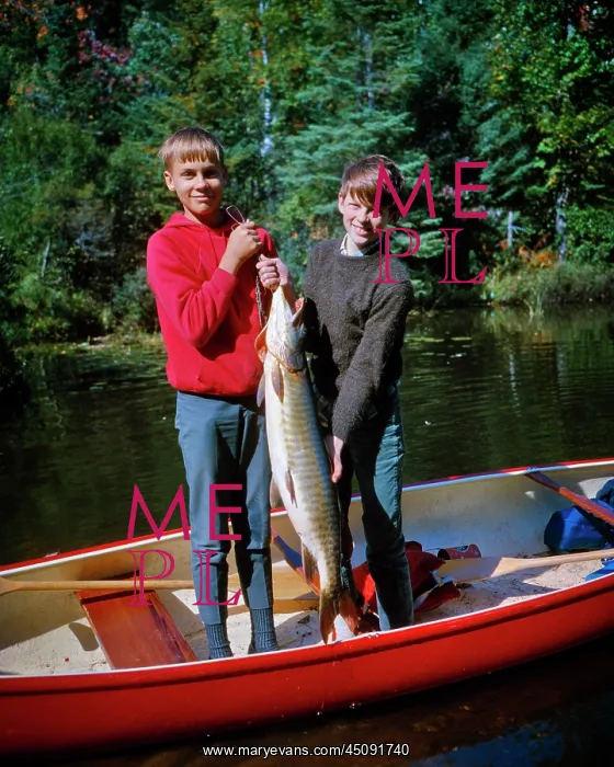: Two Smiling Boys Brothers Standing in Red Canoe : Two Smiling Boys Brothers Standing in Red Canoe