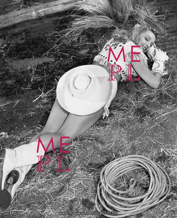  : Smiling cowgirl lying on ground