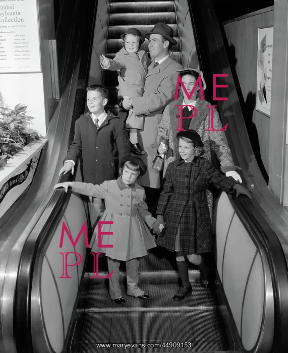 : Smiling family of 6 in winter coats going down : Smiling family of 6 in winter coats going down