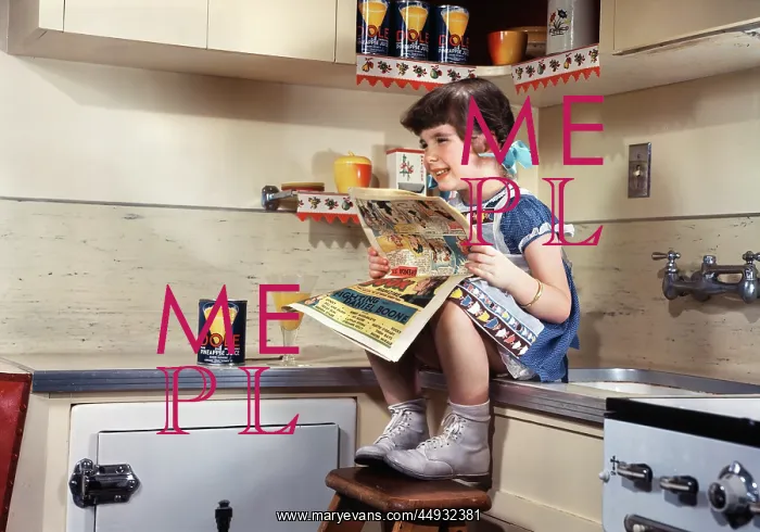 : Smiling Girl Sitting on Kitchen Counter Reading Comics : Smiling Girl Sitting on Kitchen Counter Reading Comics