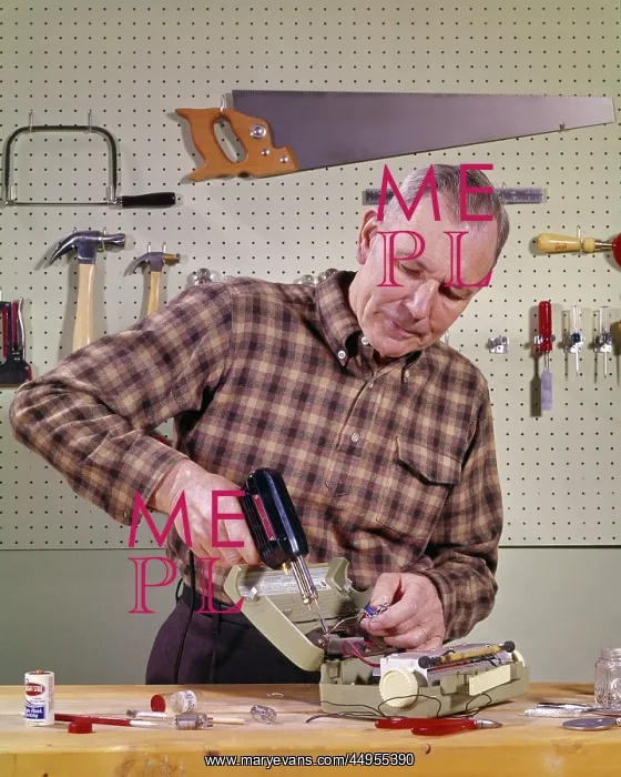 : Smiling Handyman Senior Man Holding Using a Soldering : Smiling Handyman Senior Man Holding Using a Soldering