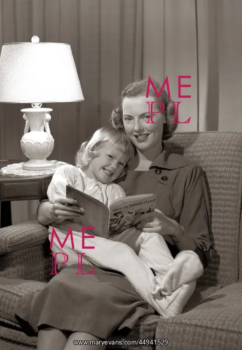 : Smiling Mother And Daughter Reading : Smiling Mother And Daughter Reading