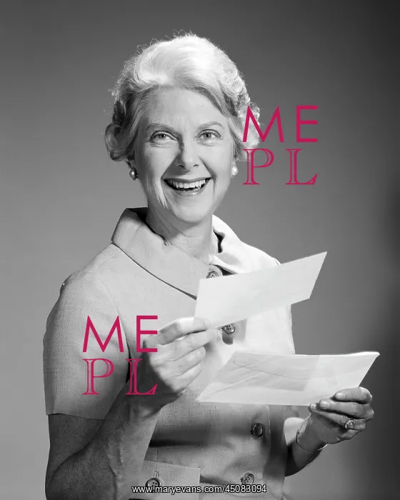 : Smiling Senior Woman looking at Camera Holding : Smiling Senior Woman looking at Camera Holding