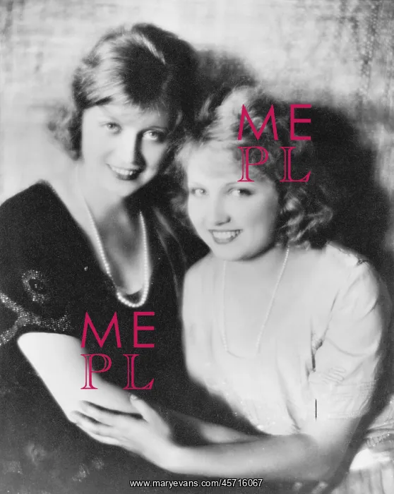 : Two smiling women holding on to each other : Two smiling women holding on to each other